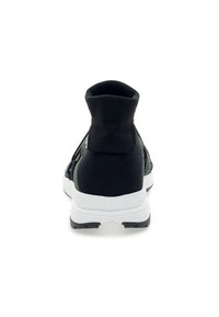 Black athletic shoe with a high, ribbed ankle collar, mesh upper, and white sole. Textured patterns on the sides add visual interest.