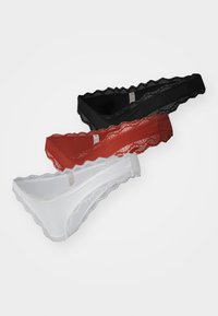 Three lace-trimmed thongs in black, red, and white, featuring a scalloped edge and smooth fabric for comfort.