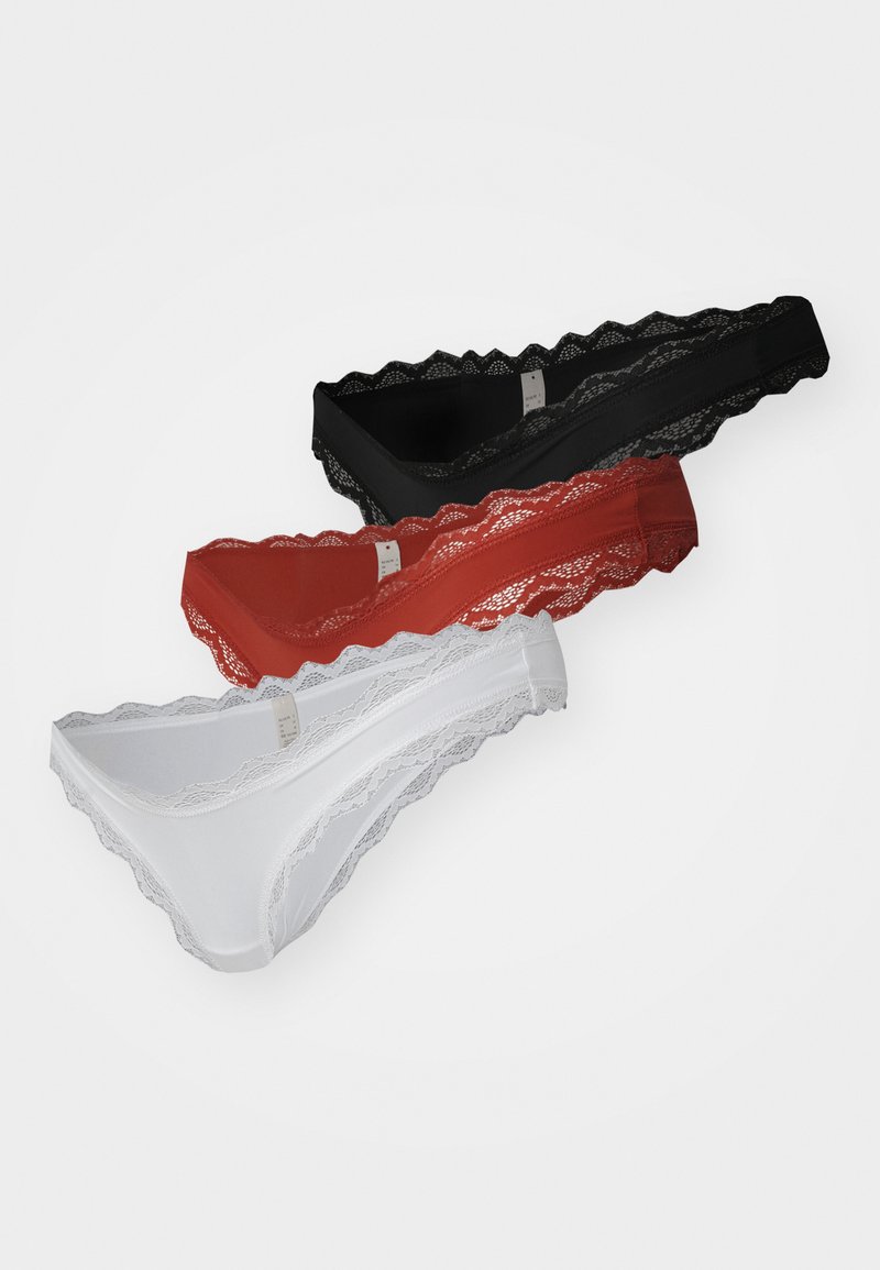 Three lace-trimmed thongs in black, red, and white, featuring a scalloped edge and smooth fabric for comfort.