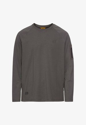 Langærmet t-shirt i mørkegrå stof, med raglanærmer, en lynlåslomme på armen og et diskret logo på brystet.