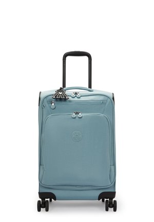 Blue soft-sided suitcase with a black retractable handle, four wheels, and a front pocket. Features a decorative black tag.