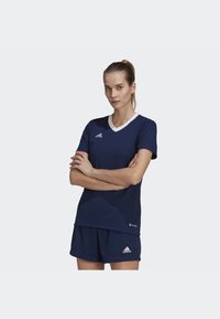 Navy blue athletic outfit with a v-neck shirt and shorts. The shirt has white trim and features the Adidas logo on the chest and shorts.