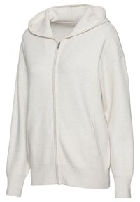 Helle beige Zip-Hoodie aus weichem Stoff. Verfügt über eine große Kapuze, zwei seitliche Taschen, gerippte Bündchen und eine lockere Passform.