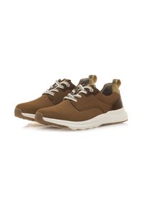 Sneakers in tessuto marrone con lacci bianchi e suola in gomma avorio. Dettagli includono un pannello marrone scuro e un'etichetta di sollevamento sul retro.