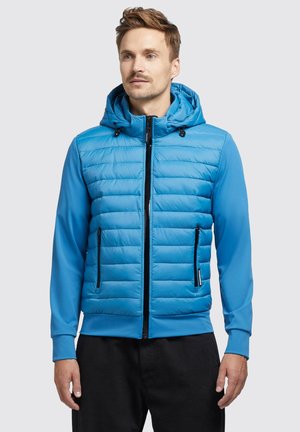 Light blue hybrid jacket with a padded torso and solid blue sleeves. Features a hood, front zipper, and two side pockets with black accents.