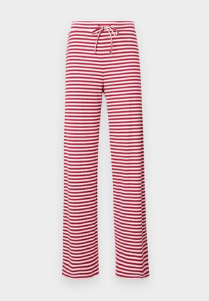 Pantalone s crveno-bijelim prugama, slobodnog kroja s elastičnom čijom i rebrastom teksturom. Izravni kroj nogavica proteže se do dužine gležnjeva.