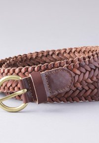 Brown braided leather belt with a circular brass buckle and a smooth leather end; features detailed weaving and sturdy stitching.