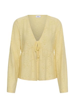 Blouse à manches longues jaune pâle avec encolure en V, texture florale subtile et fermeture à nouer à l'avant.