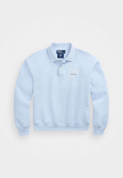 Sweatshirt de algodão azul claro com mangas longas, gola de três botões e logo de louros bordado no lado esquerdo do peito. Textura suave.