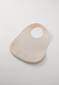 Soft beige silicone bib with rounded neck opening, contoured edges, and no additional textures or patterns. Lightweight and easy to clean.