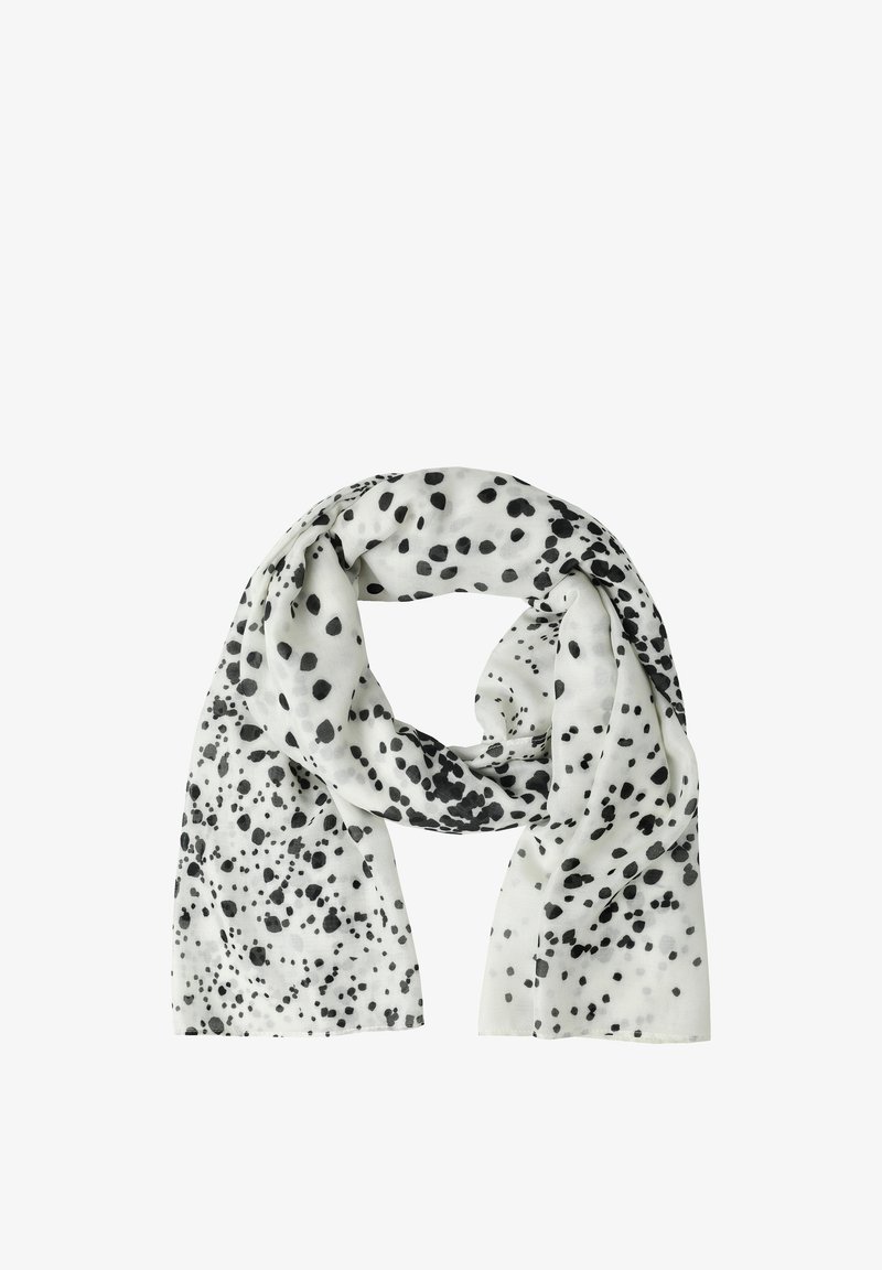 Écharpe blanche avec des taches noires irrégulières de tailles variées, pliée lâchement sur un fond blanc.