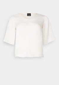 Lett hvit bluse i lett stoff, med V-hals og vide ermer. Glatt tekstur med en avslappet passform og rett kant.