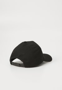 Sort baseball cap med en rund krone, tekstureret stof og en justerbar plastrem bagpå.