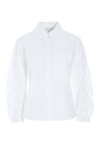 Camicia bianca in cotone con colletto classico, placca con bottoni, maniche lunghe con dettagli in bottone e taschino sul petto. Tessuto morbido.