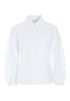 Camicia bianca in cotone con colletto classico, placca con bottoni, maniche lunghe con dettagli in bottone e taschino sul petto. Tessuto morbido.