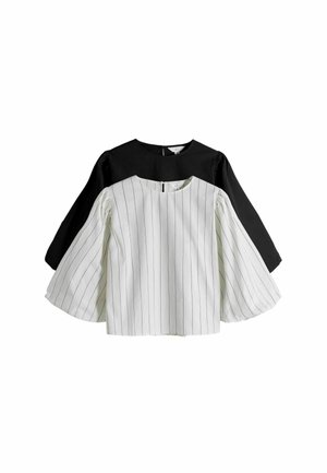 Two-tone blouse with black and white fabric. Black back, white front with vertical stripes. Features wide, flared sleeves and round neckline.