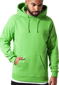 Felpa verde con tasca a marsupio, cordini per la regolazione, polsini e orlo a costine, realizzata in un materiale morbido e texturizzato.