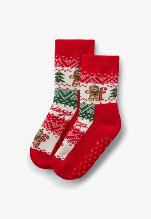 Červené ponožky s vzory perníkových mužíků, vánočních stromků a svátečních motivů. Podešve mají gripové body pro lepší přilnavost.