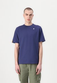 Navy blue cotton T-shirt with short sleeves, round neck, and a white logo on the chest. Features yellow accents on the sleeve hems.