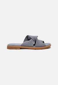 Gray slide sandals with quilted fabric straps, open toe design, and a tan rubber sole. Textured material with diagonal ribbing details.