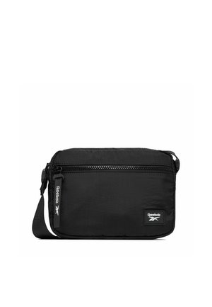 Borsa a tracolla nera Reebok con tasca frontale con cerniera, tiretto brandizzato e tracolla regolabile su sfondo bianco.