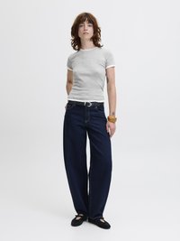 Gray short-sleeve t-shirt with white trim, paired with dark blue wide-leg jeans and black flats. Casual fit, simple design.