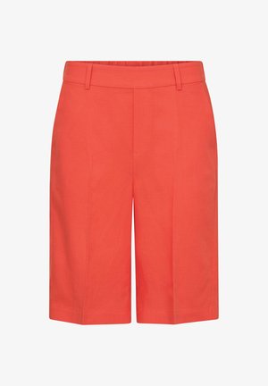 Korallpunased põlveni ulatuvad lühikesed püksid vööaasadega, esiseamade detailide ja siledast kangast.