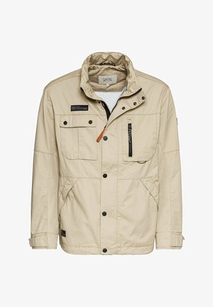 Veste d'extérieur beige en tissu léger, dotée d'un col montant, de plusieurs poches, de boutons-pression et d'une fermeture éclair à l'avant.