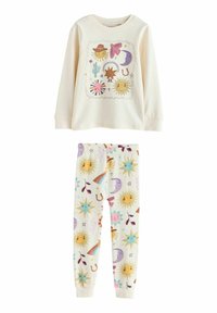 Top crem cu mâneci lungi, decorat cu un imprimeu grafic colorat cu Soare și forme; pantalonii de pijama asortați au modele celestiale strălucitoare și jucăușe.