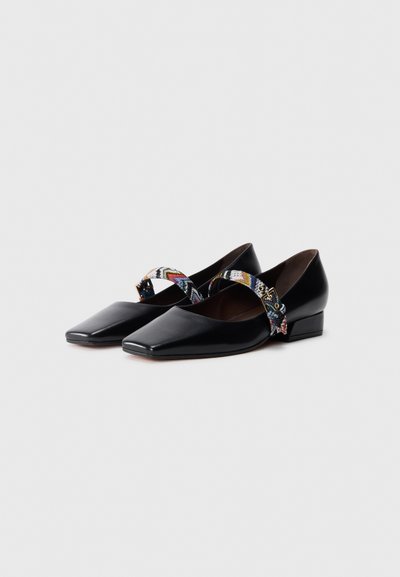 Black leather shoes with a squared toe and low heel, featuring a multicolored woven strap across the instep. Smooth texture.