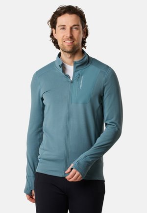 Hellblaues Zip-Up-Jacke aus strukturiertem Stoff, mit Stehkragen und einer Brusttasche mit Logo-Detail. Lange Ärmel mit Daumenlöchern.