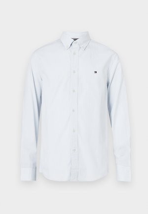 Light blue striped long-sleeve shirt with a button-down collar and a small logo on the chest; made of cotton fabric, featuring white buttons.