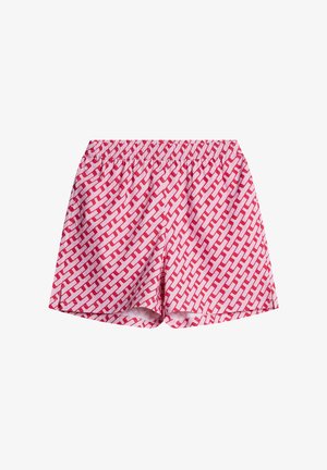 Calções em padrão vermelho e branco com uma cintura elástica; apresentam um design geométrico com formas interligadas. Textura de tecido suave.