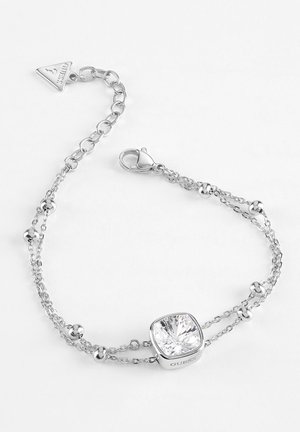 Bracelet à double chaîne en argent avec de petites perles rondes et un cristal clair carré central, avec un fermoir mousqueton et un pendentif triangulaire marqué.