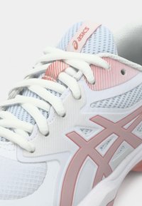 Λευκό αθλητικό παπούτσι με ροζ λεπτομέρειες, πλέγμα στο πάνω μέρος, υφή στην επιφάνεια και λευκά κορδόνια. Διαθέτει το λογότυπο της ASICS και χαρακτηριστικό σχέδιο στη πλευρά.