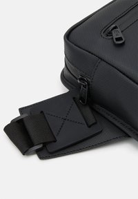 Lacoste NAOS UNISEX - Jostas soma - noir