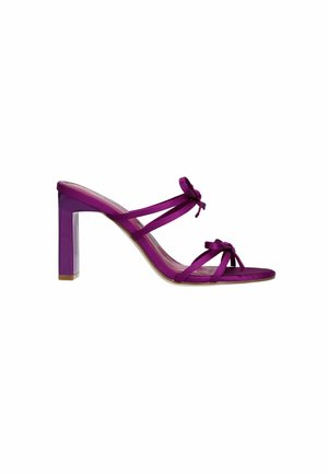 Purple high-heeled sandal with transparent block heel, featuring multiple satin straps and decorative bows on the front. Smooth texture.