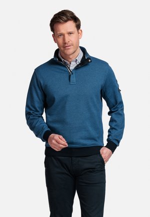 Blauwe pullover sweatshirt met een kwart ritssluiting, ribgebreide kraag en manchetten. Geweven stof, accent op een zwarte kraag en een patch op de mouw.