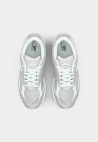 Light gray running shoes with mesh and suede upper, white accents, rubber sole, padded collar, and lace-up design. Visible branding on tongue.