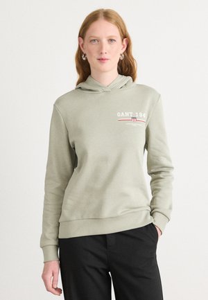 Light green hoodie made of soft fabric, featuring a kangaroo pocket, ribbed cuffs, and a graphic print with "GANT 194" on the chest.