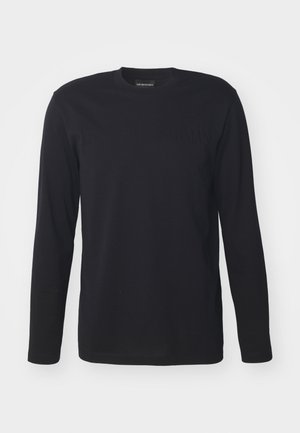 Black long-sleeve t-shirt made of cotton. Features a round neckline and embossed logo detail on the front. Smooth texture, regular fit.