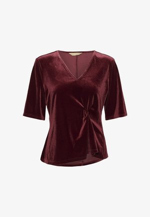 Burgundy velvet top with a V-neck, short sleeves, and a twisted front detail. Smooth texture and flowing design with a slightly curved hem.