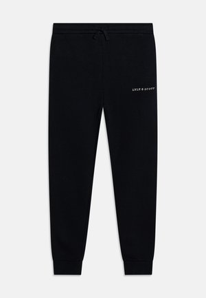 Schwarze Jogginghose aus Baumwolle, mit einem elastischen Bund und verstellbarem Kordelzug sowie einem kleinen weißen Logo an der Oberschenkelseite. Mit schmal zulaufendem Bein.