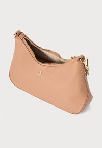 Peach-colored faux leather bag with a textured surface, gold zipper, and a logo accent. Compact shape, suitable for small essentials.