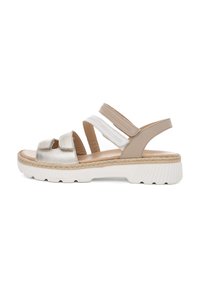 Sandals with silver metallic straps, beige accents, and a white textured sole. Features an adjustable back strap and two elastic bands.