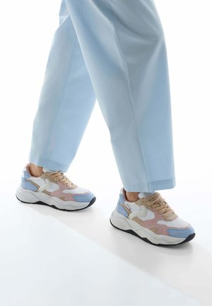 Multicolored sneaker featuring a combination of light blue, pink, and beige textiles with a textured white sole and round laces.