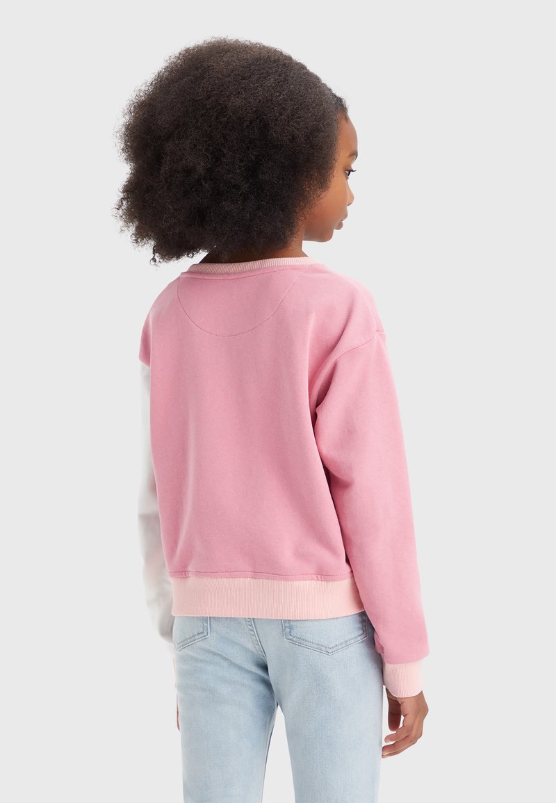 Sweatshirt rose avec un col rond, des poignets côtelés et un ourlet. Conception en color-block avec des manches blanches. Tissu doux en mélange de coton.