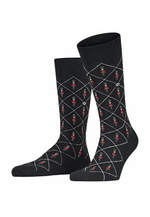 Schwarze Socken mit einem Diamantmuster, das rote und graue Spielzeugsoldaten zeigt. Hergestellt aus weichem Material mit glatter Textur und mit sauberen Abschlüssen.