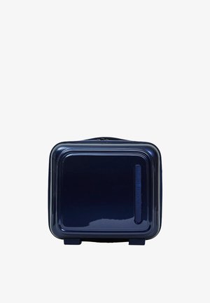 Maleta rígida de color azul marino con un acabado brillante, forma cuadrada y bordes redondeados. Cuenta con un zipper superior y una sutil marca en el lateral.