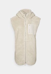 Kamizelka z polaru w jasnym beżu z zamek błyskawicznym z przodu i małą kieszenią na zamek po lewej stronie. Bez rękawów, miękka w dotyku.